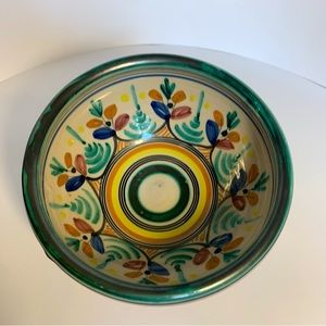 Colorful glazed bowl, 2 1/2” deep, 5 1/2” across, floral and striped.